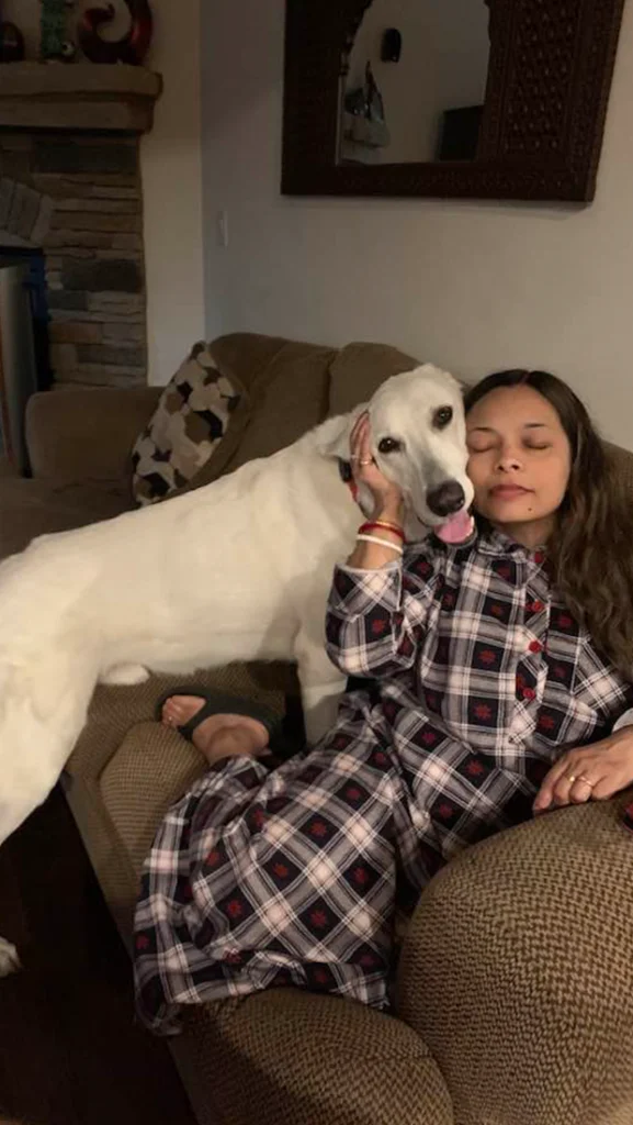 Buddies Overnight Pet Sitter Cuddling a Dog on the Couch